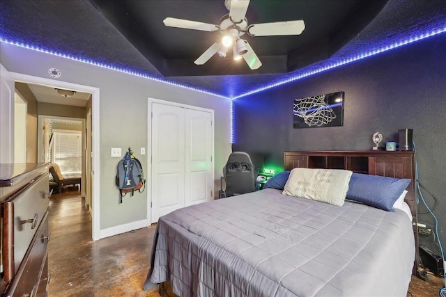265 Callie Ln, Orange, TX 77632 - bedroom featuring concrete floors, baseboards, a closet, and a ceiling fan