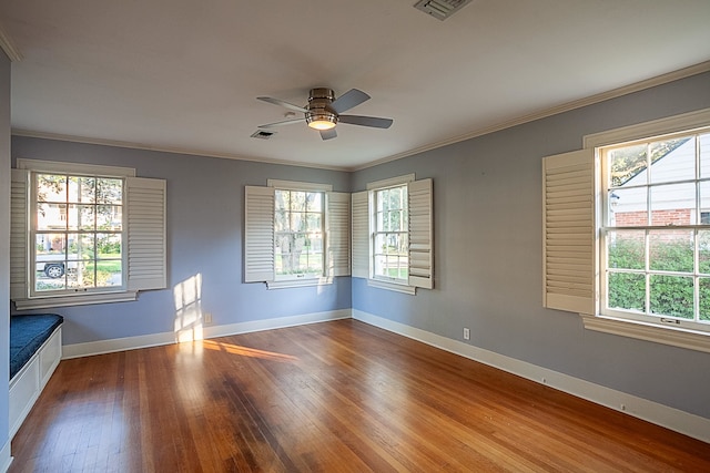 unfurnished room with hardwood / wood-style floors, ceiling fan, and ornamental molding