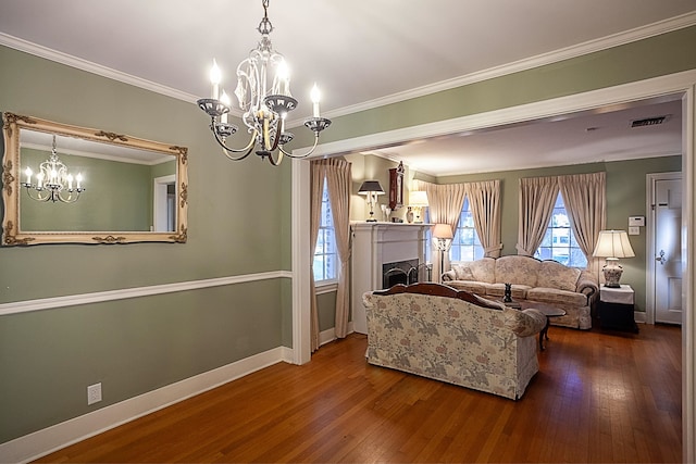 living room with a chandelier, hardwood / wood-style flooring, and ornamental molding