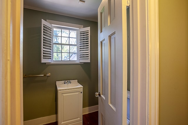 bathroom with vanity, wood-type flooring, and ornamental molding