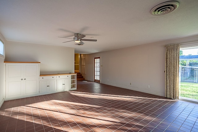 spare room featuring ceiling fan and tile patterned flooring