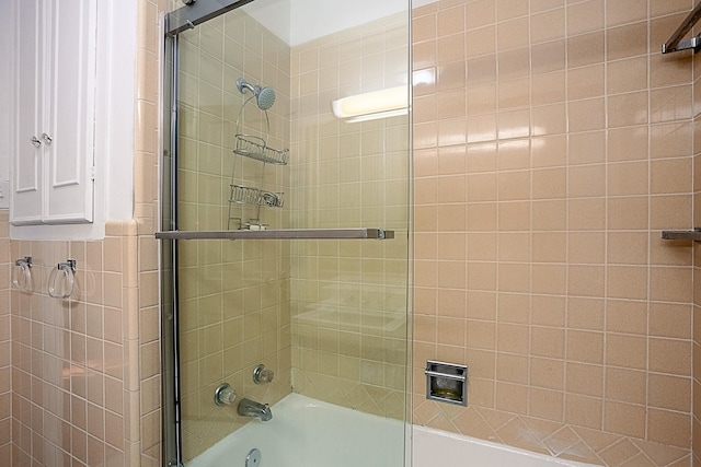 bathroom featuring shower / bath combination with glass door