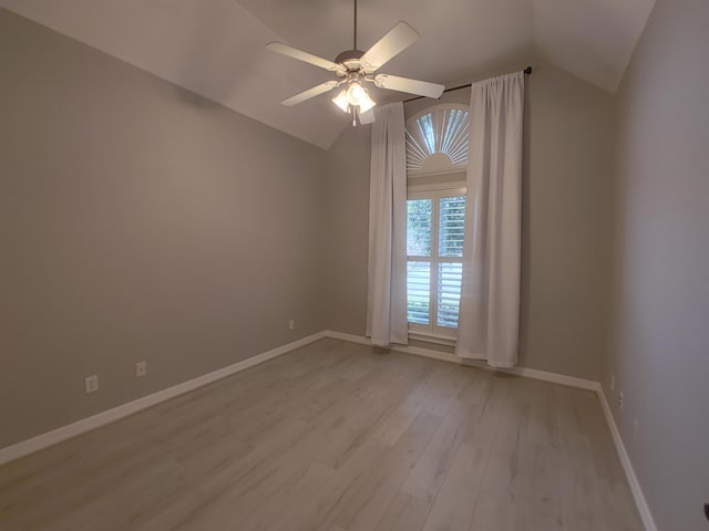 empty room with ceiling fan, lofted ceiling, and light hardwood / wood-style flooring