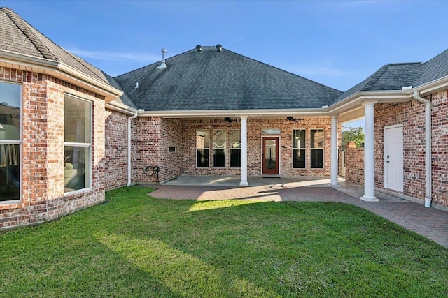 back of house with a yard and a patio area