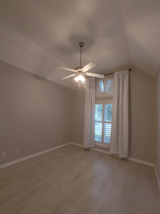 interior space with ceiling fan, lofted ceiling, and light hardwood / wood-style floors