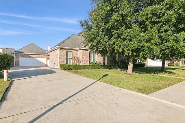 view of property hidden behind natural elements with a garage and a front lawn