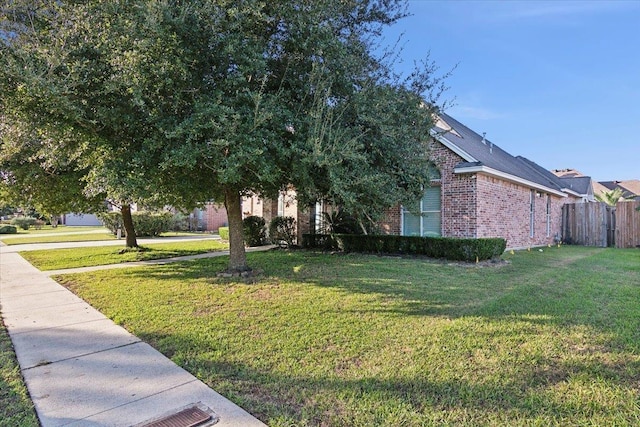 view of side of home with a yard