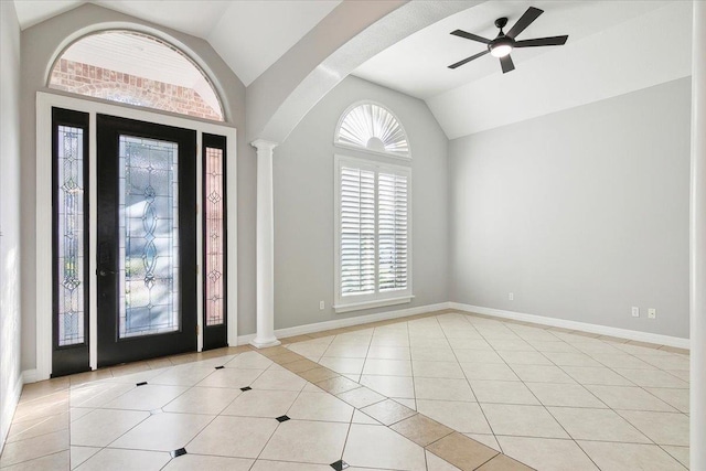 tiled entrance foyer featuring ceiling fan, lofted ceiling, and ornate columns