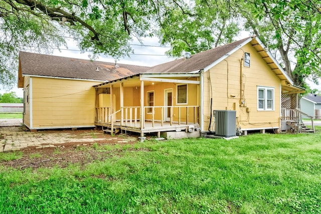 3500 32nd St, Port Arthur, TX 77642 - rear view of property featuring a shingled roof, a yard, and covered porch