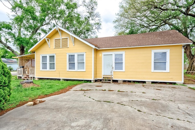 3500 32nd St, Port Arthur, TX 77642 - back of house featuring a shingled roof and entry steps