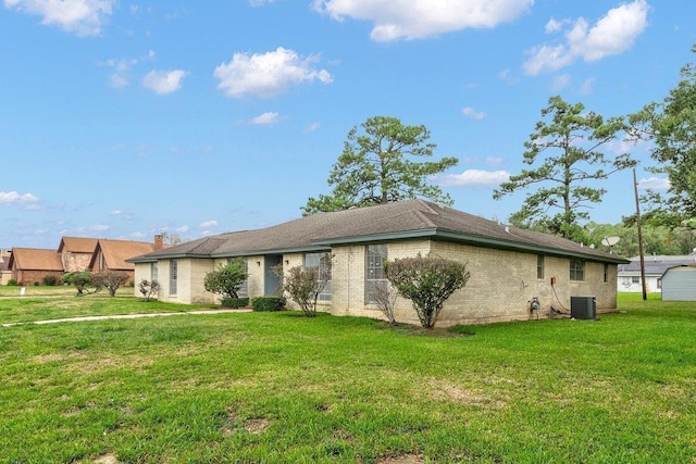 exterior space featuring a front lawn and central AC