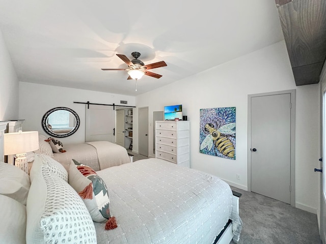 bedroom featuring carpet floors, a ceiling fan, baseboards, and a barn door