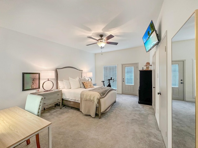 bedroom featuring access to exterior, light colored carpet, and ceiling fan