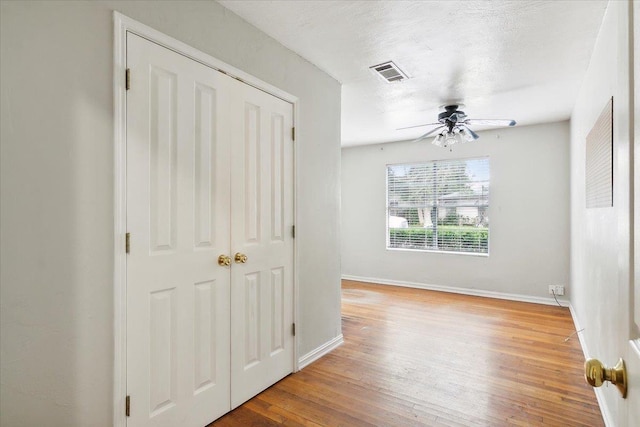 interior space featuring a textured ceiling and light hardwood / wood-style floors