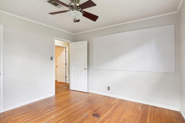 spare room with ceiling fan, ornamental molding, and light hardwood / wood-style flooring