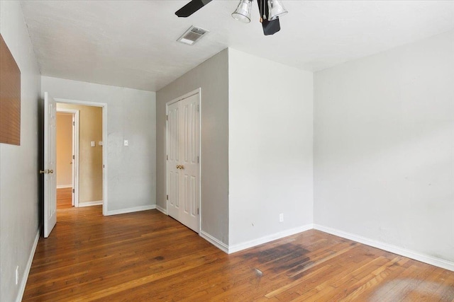 empty room with dark hardwood / wood-style flooring