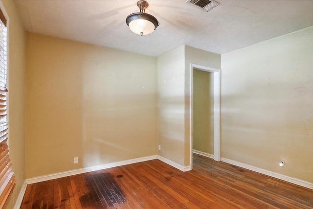 empty room with hardwood / wood-style flooring