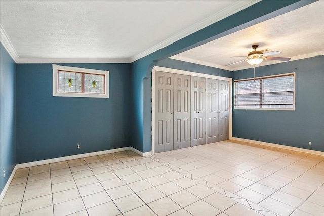 unfurnished bedroom with crown molding, vaulted ceiling, ceiling fan, a textured ceiling, and light tile patterned flooring