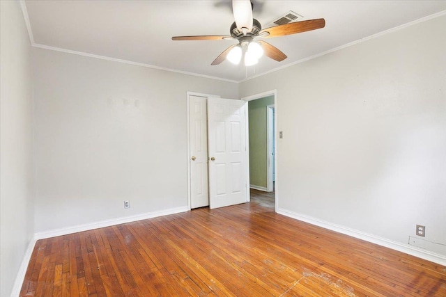 empty room with ceiling fan, crown molding, and light hardwood / wood-style flooring