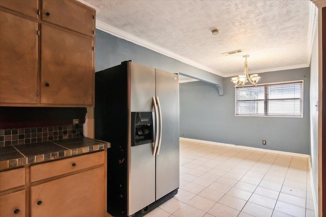 kitchen with decorative backsplash, an inviting chandelier, stainless steel refrigerator with ice dispenser, and ornamental molding