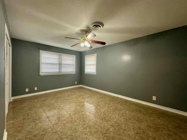 spare room with ceiling fan