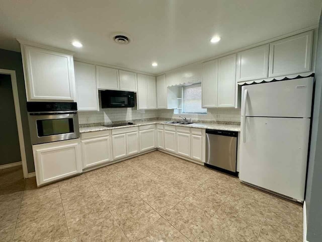 kitchen featuring backsplash, black appliances, sink, light stone counters, and white cabinetry