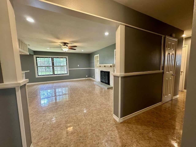 unfurnished living room with ceiling fan