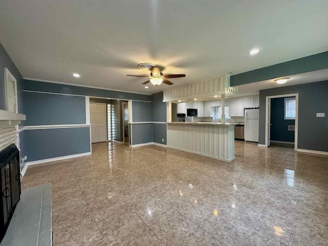 unfurnished living room with ceiling fan