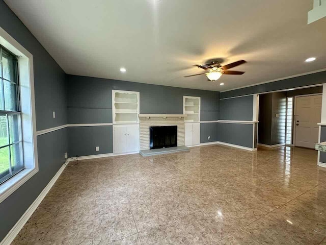 unfurnished living room featuring ceiling fan and a fireplace