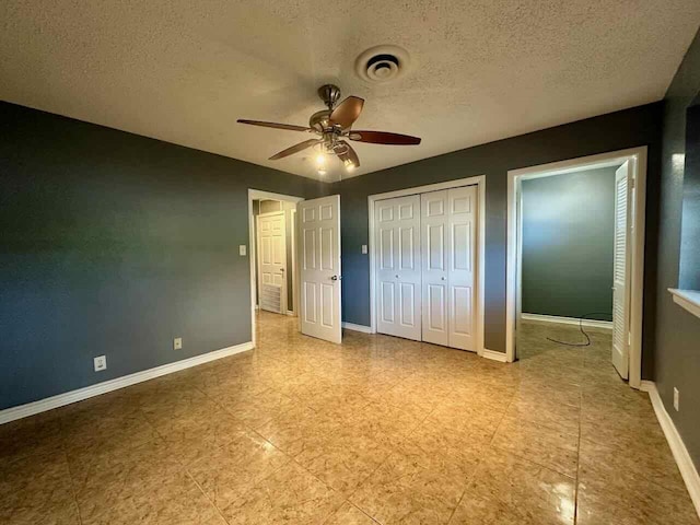 unfurnished bedroom with ceiling fan and a textured ceiling