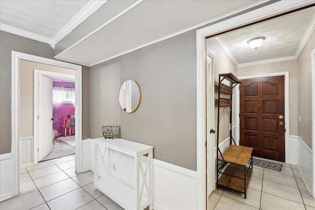 foyer entrance featuring light tile patterned flooring and ornamental molding