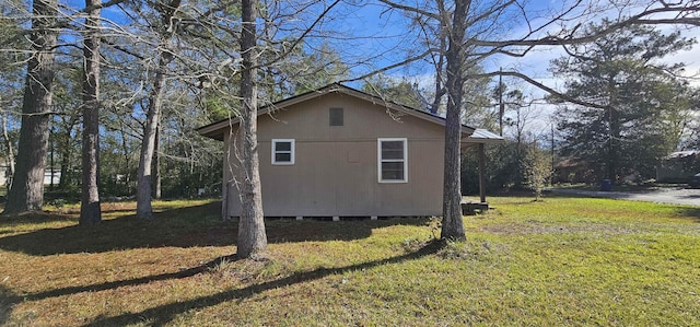 view of property exterior featuring a lawn and a storage unit