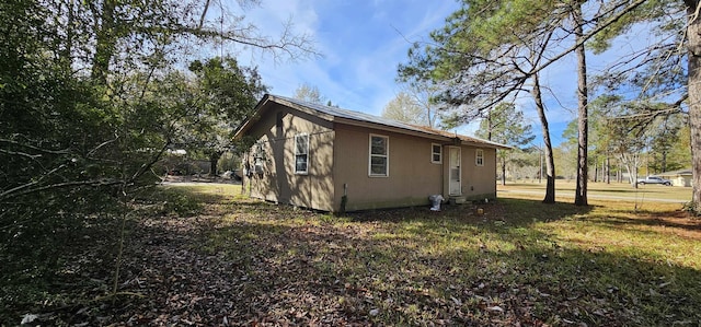 view of home's exterior with a yard