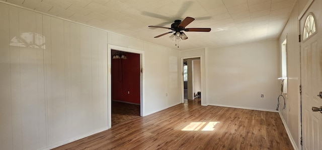 unfurnished room with wood-type flooring, plenty of natural light, and ceiling fan