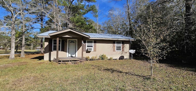 bungalow-style home featuring cooling unit and a front lawn