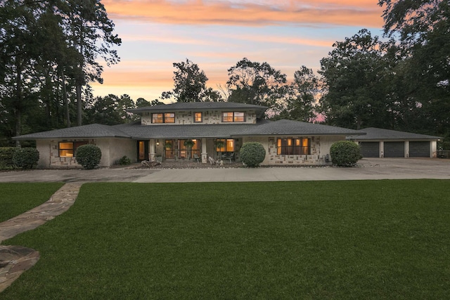 1025 Creek Bend Dr, Jasper, TX 75951 - prairie-style home with curved driveway, a front lawn, stone siding, a garage, and a porch