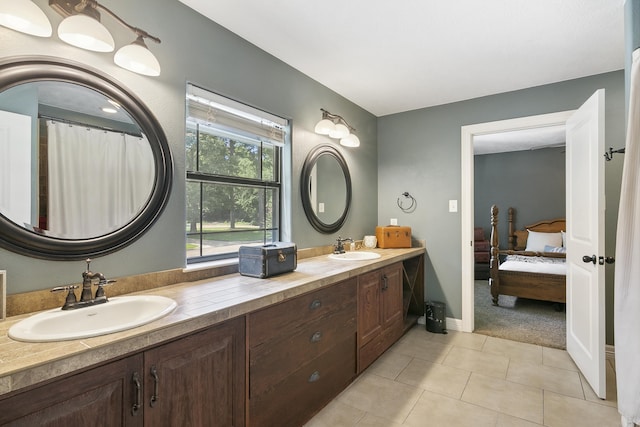 1025 Creek Bend Dr, Jasper, TX 75951 - bathroom with double vanity, tile patterned floors, baseboards, and connected bathroom