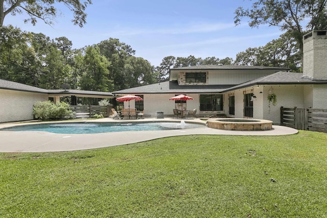 1025 Creek Bend Dr, Jasper, TX 75951 - back of property with brick siding, a chimney, a patio, and a pool with connected hot tub