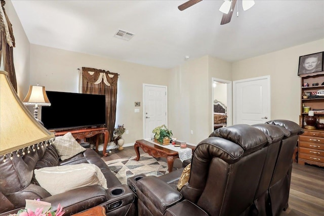 living room with a ceiling fan, baseboards, visible vents, and wood finished floors