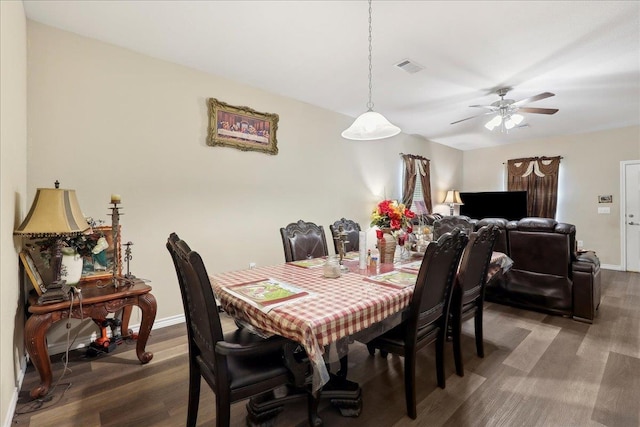 dining space with a ceiling fan, visible vents, baseboards, and wood finished floors