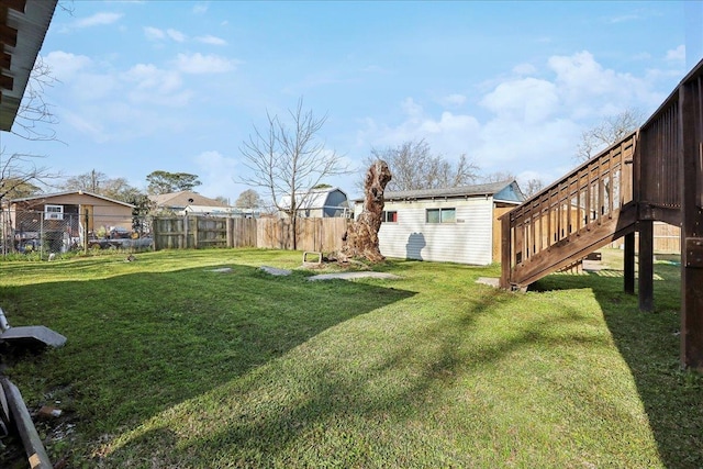 view of yard featuring an outdoor structure and fence