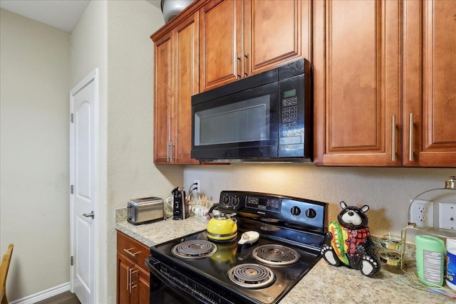 kitchen with brown cabinets and black appliances