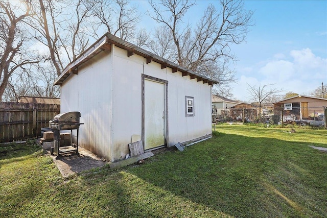 view of outbuilding featuring an outdoor structure and fence