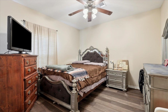 bedroom featuring ceiling fan, dark wood-style flooring, and baseboards