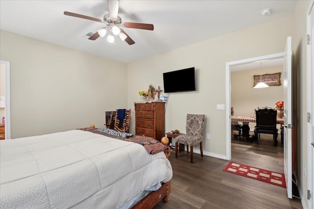 bedroom with dark wood-type flooring, visible vents, ceiling fan, and baseboards