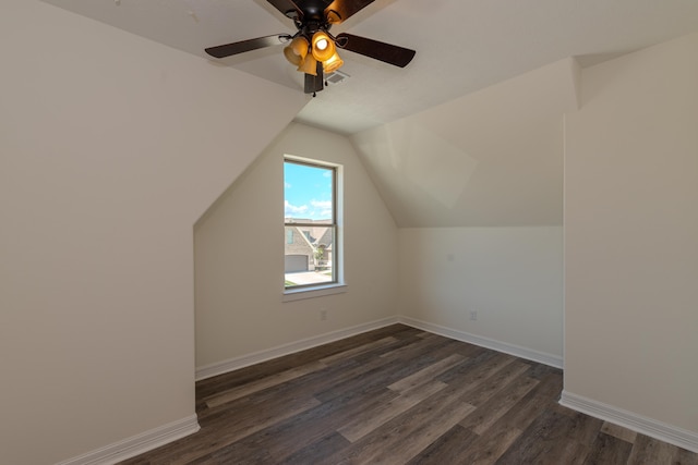 bonus room featuring lofted ceiling, baseboards, visible vents, and dark wood finished floors