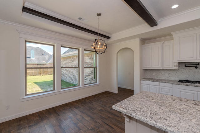 kitchen with arched walkways, visible vents, white cabinets, backsplash, and dark wood-style floors