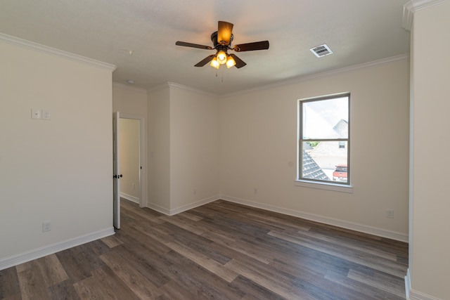 spare room with baseboards, visible vents, dark wood-style flooring, and ornamental molding