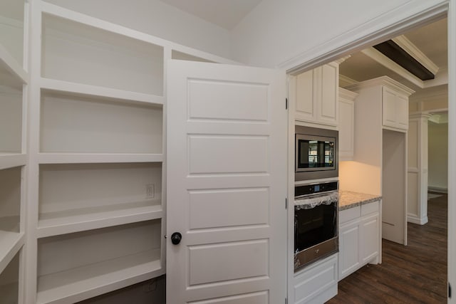 kitchen with white cabinets, open shelves, stainless steel appliances, and dark wood-type flooring