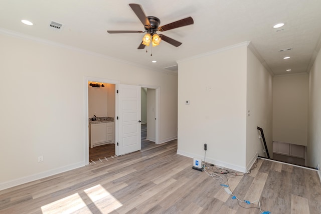 unfurnished room with ornamental molding, baseboards, visible vents, and light wood finished floors